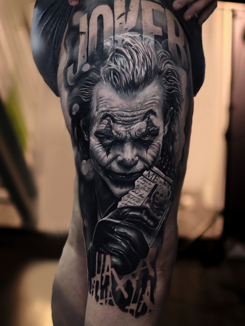Tattoo of a detailed black and white illustration of a character on a person's arm.