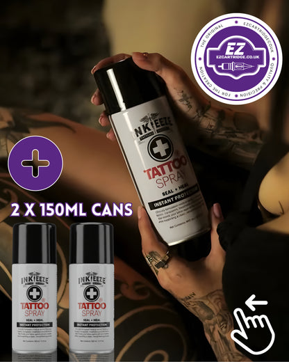 Person holding two 150ml cans of InkeezeTattoo Spray with a visible brand logo.